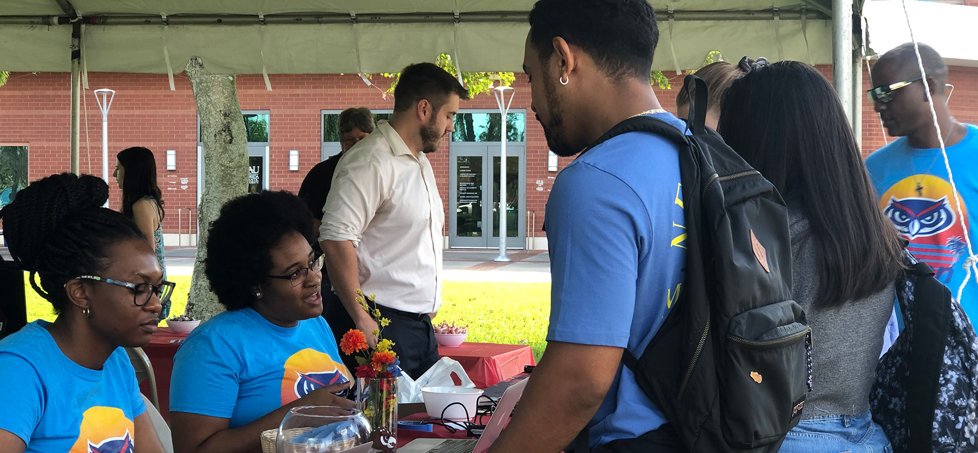 Students interacting at a campus booth
