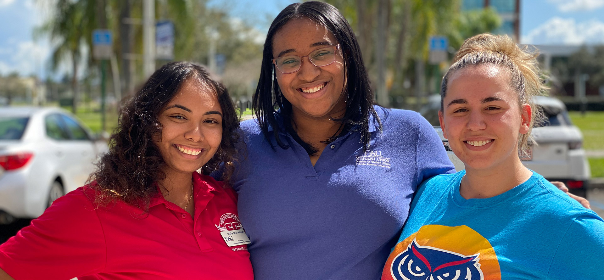 Three students smiling