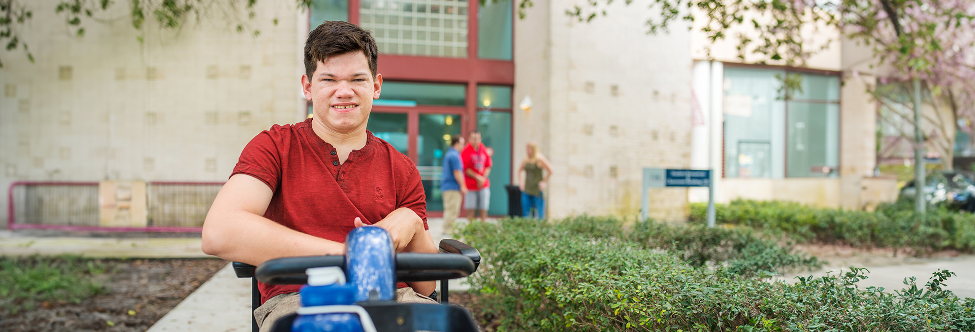 Student using a motorized mobility device on FAU campus