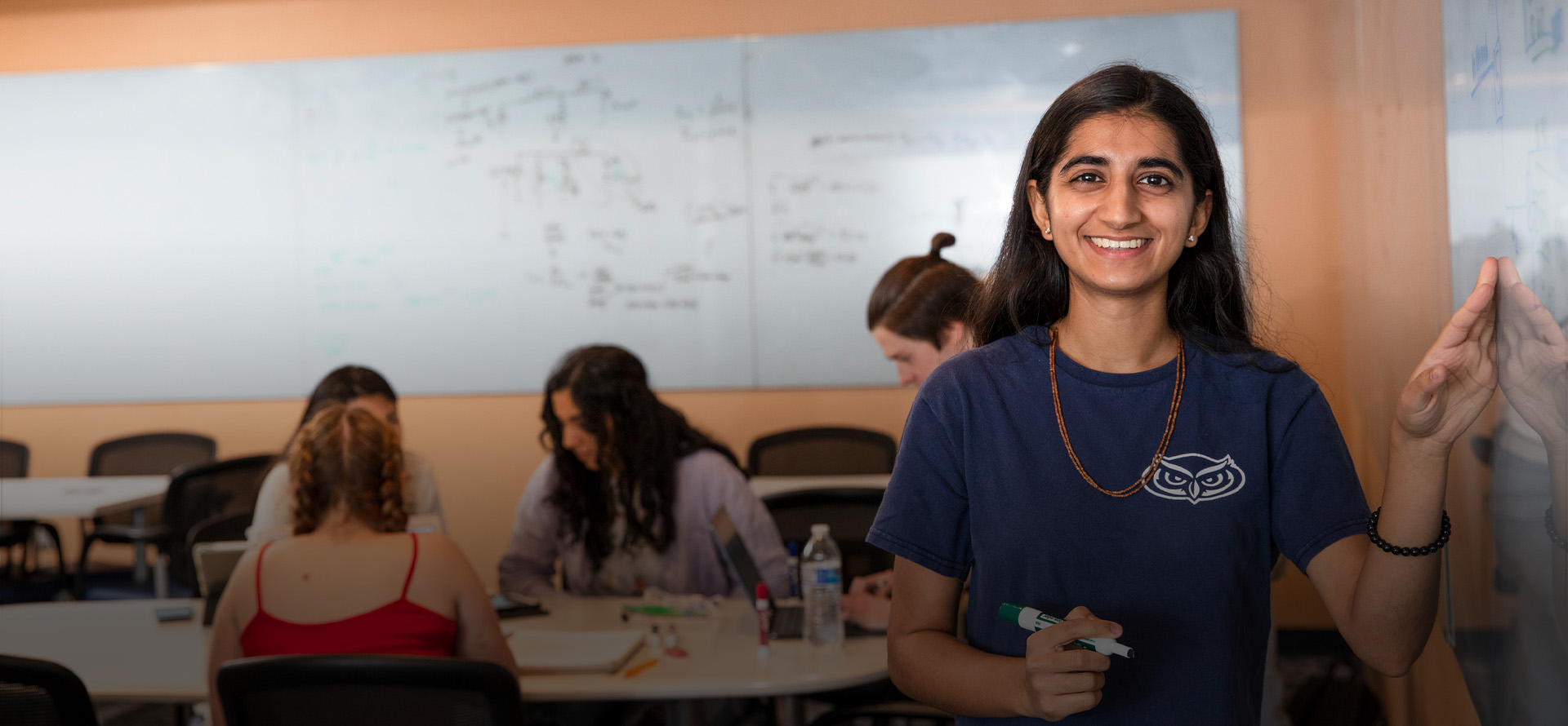 FAU student tutor in front of white board
