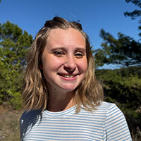 headshot of student standing outside on a sunny day