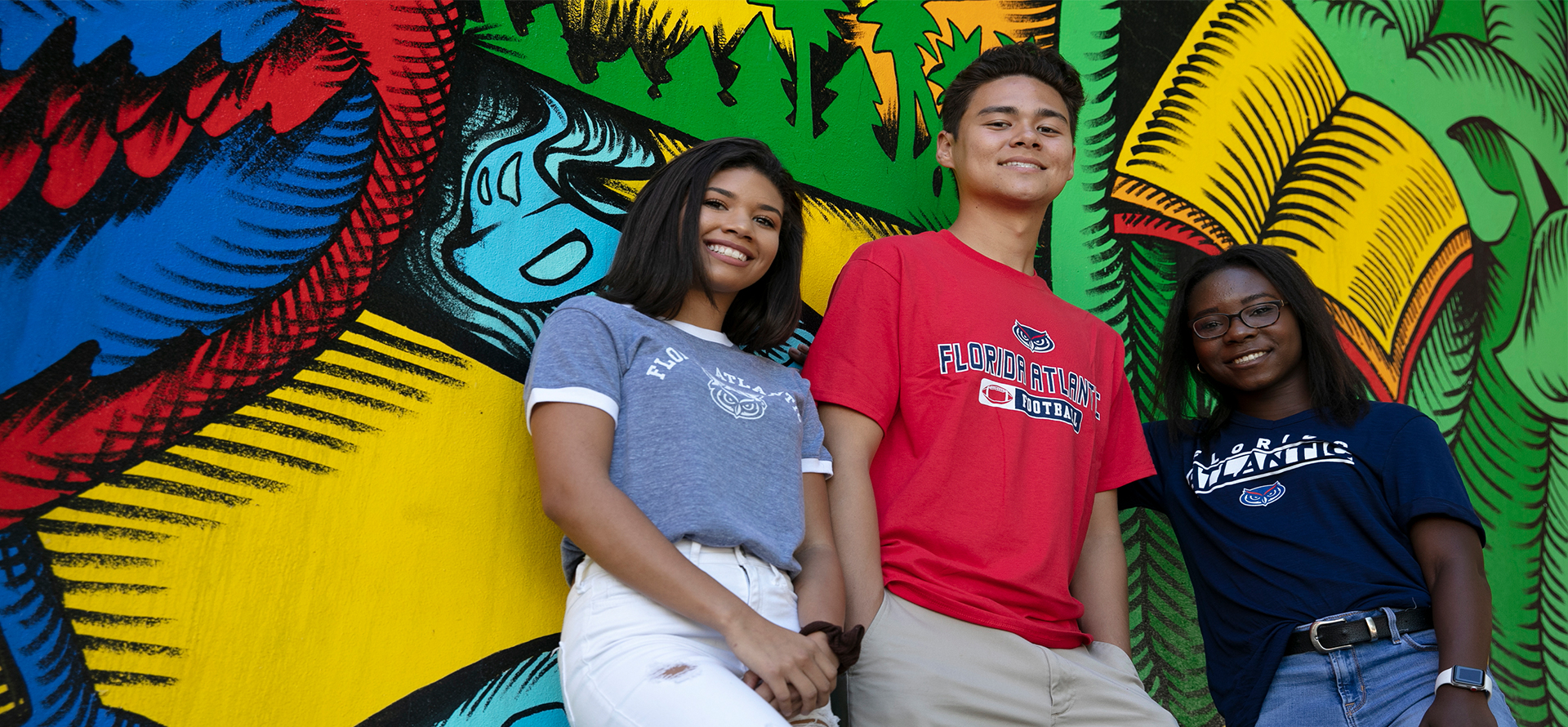 Diverse Group of Students in Front of a student painted wall
