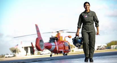 Cristina Silva walking with coast guard helicopter in background.