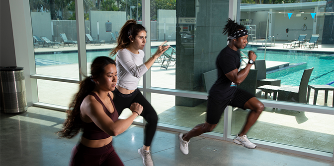 Three students running at the on campus gym
