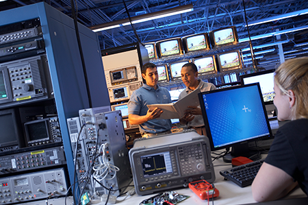 Two male and one female student in computer lab