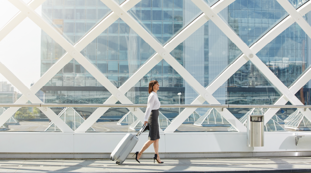 woman pulling suitcase over walkway